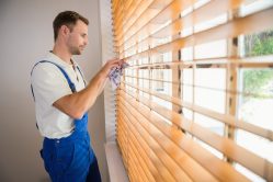 Good Clean Employee Cleaning Window Blinds