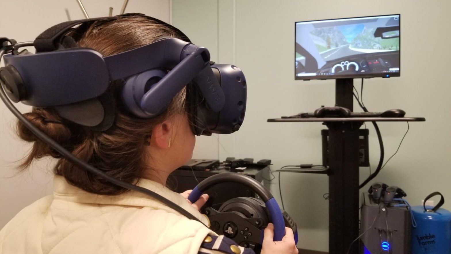 woman in VR googles driving steering wheel