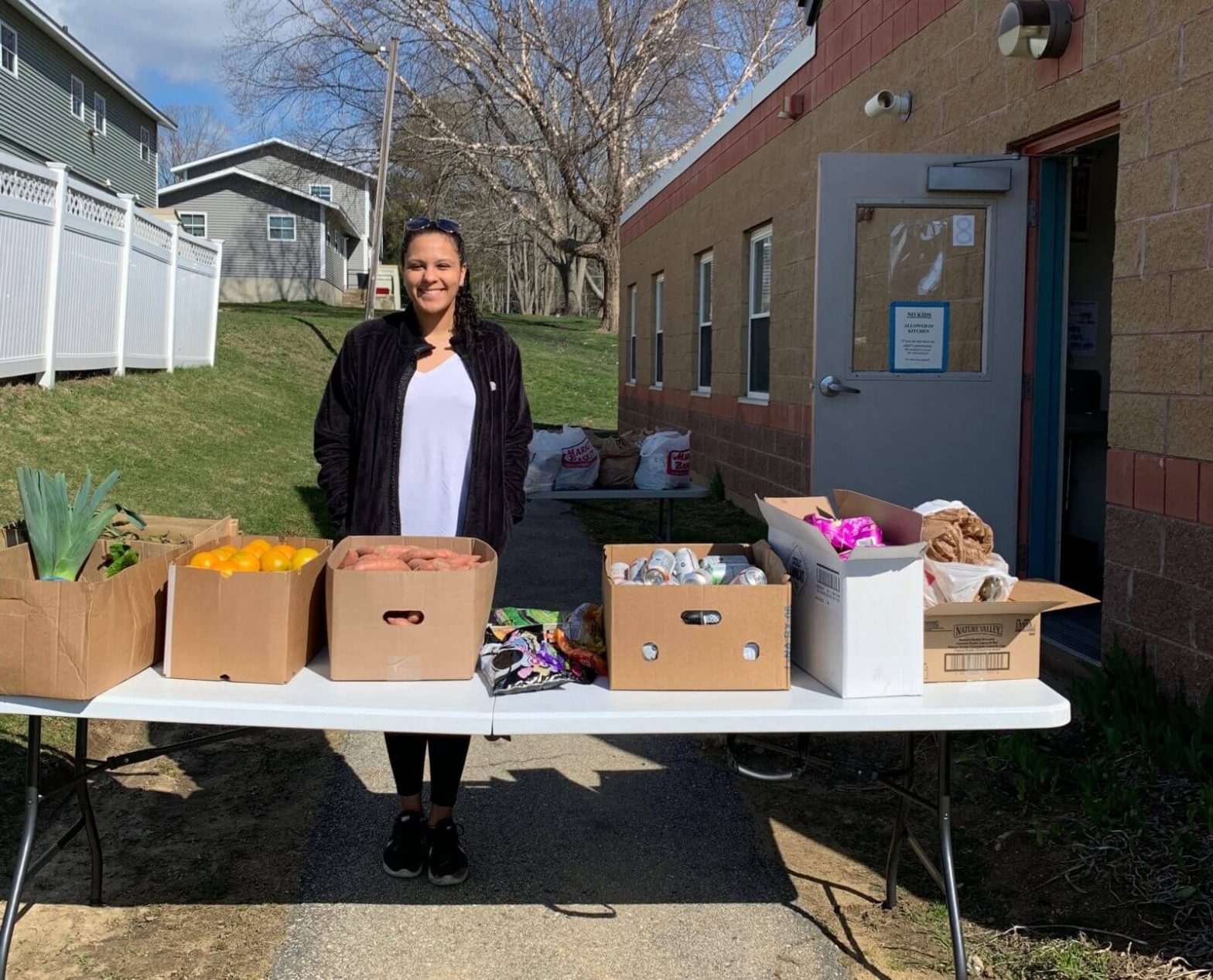 an AmeriCorps member gives our groceries to those in need