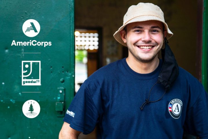 A man smiles and wears an Americorps shirt