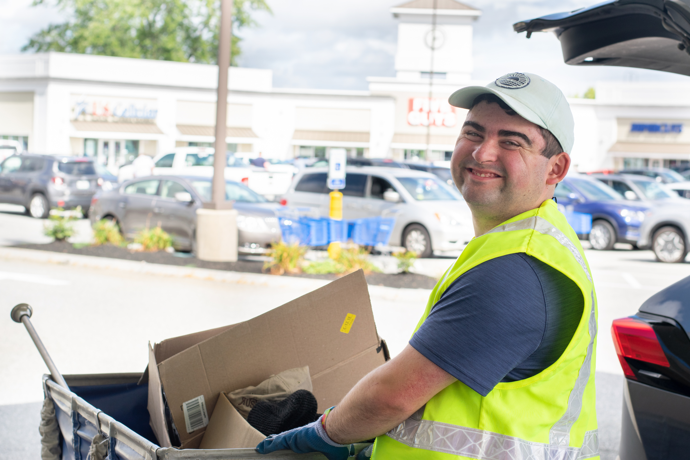 Evan smiling while collecting Goodwill donations outside.