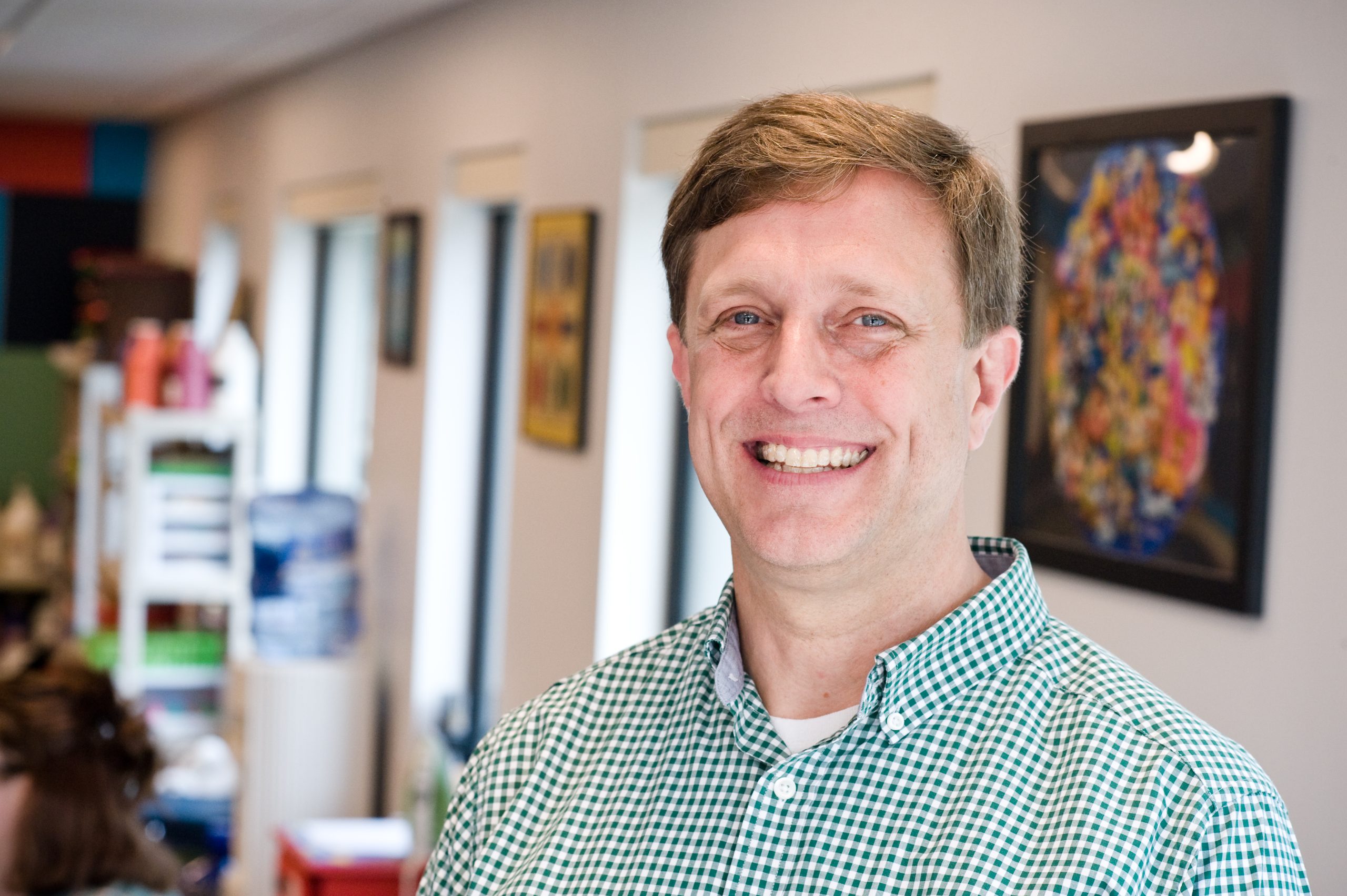 Rich Cantz smiles at the camera in front of Goodwill LifeWorks deaf services