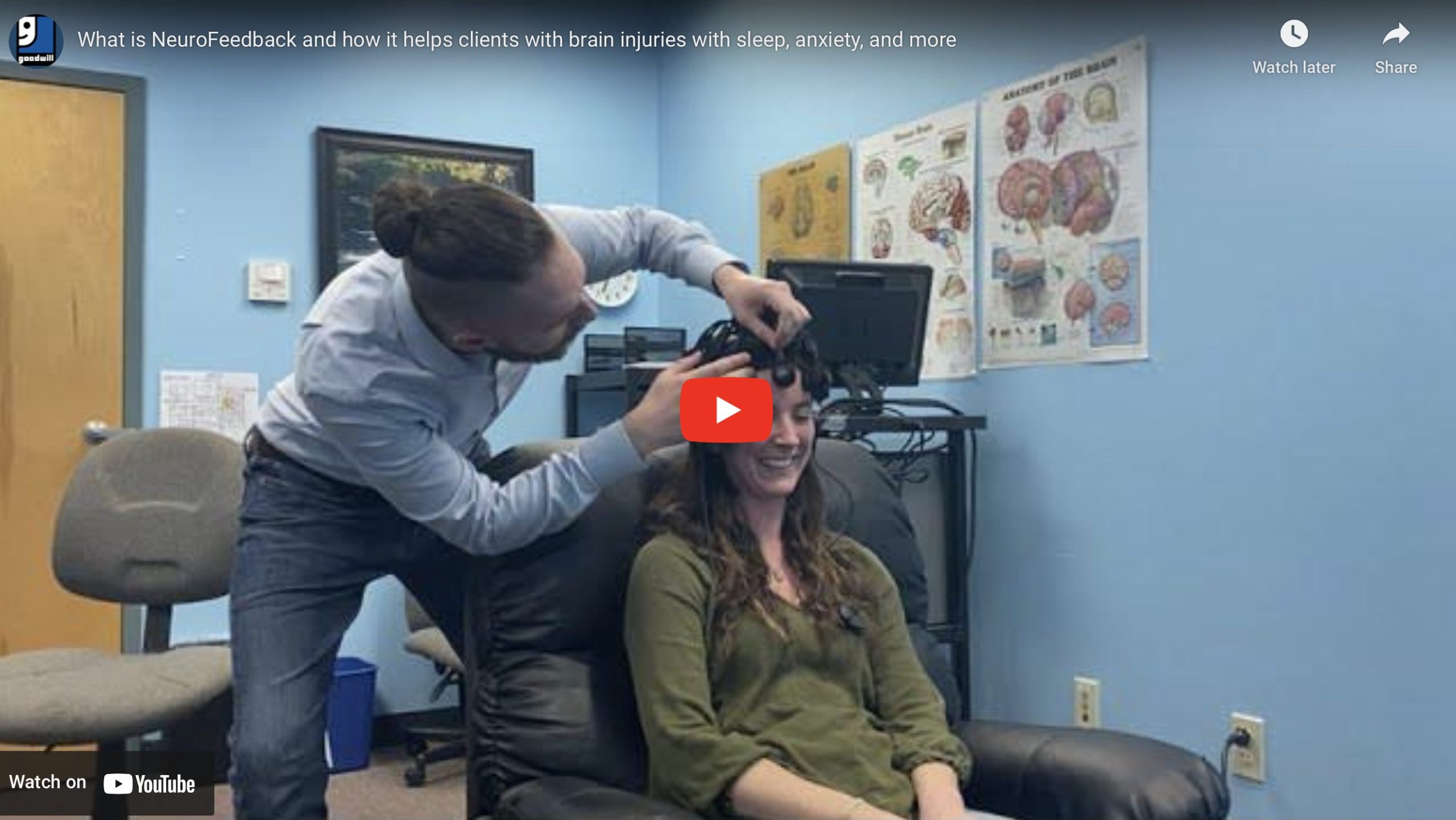 A healthcare professional secures a cap on a woman's head. The cap is for NeuroFeedback and has electrodes all over it to read brainwaves.