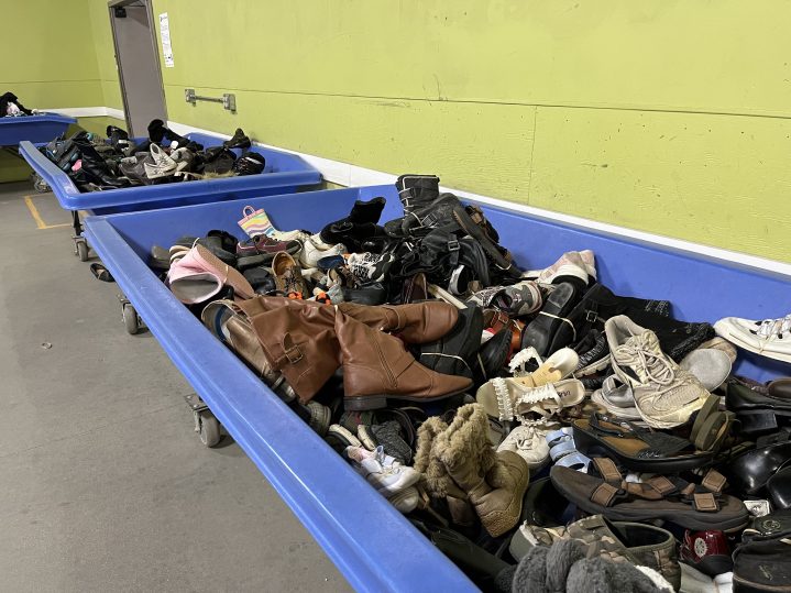 A long blue bin filled with donated shoes at the Goodwill Buy The Pound outlet.