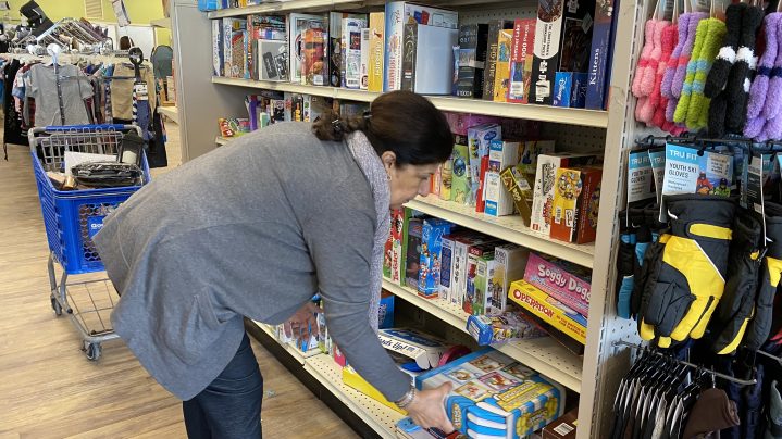 Rajaa putting items on the sales floor at Goodwill. 