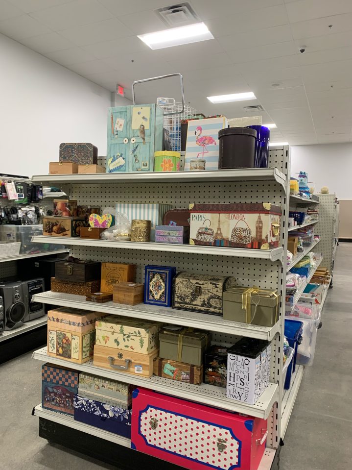 A full shelf, stocked with photo boxes and collectable storage boxes with fun patterns all at the new Hooksett, NH Goodwill NNE store.