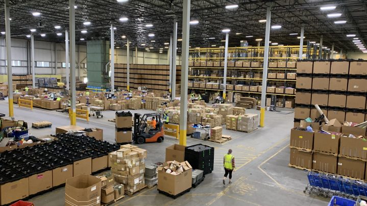 Scene of the Goodwill NNE warehouse with lots of large boxes and forklifts.