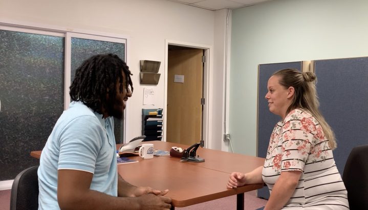 Trevon Butler meeting with a coworker about about people with disabilities getting jobs
