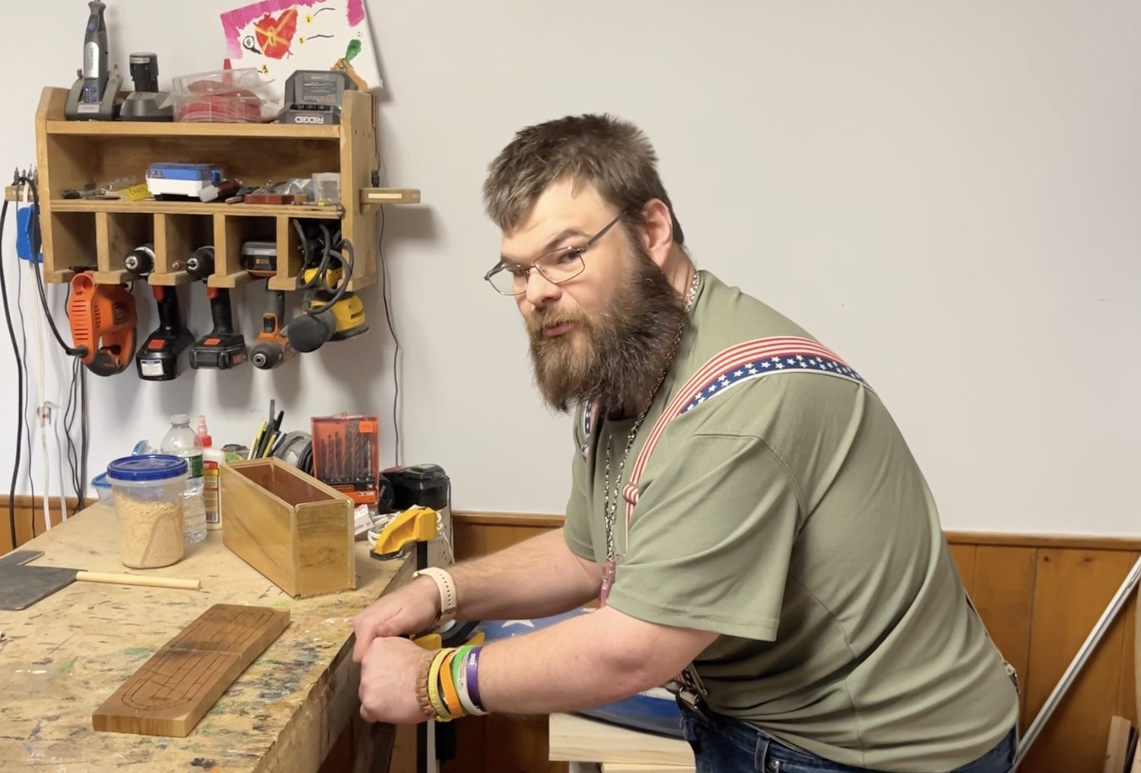 Caleb Truman stands near a workbench he uses through Goodwill's Disability Services.