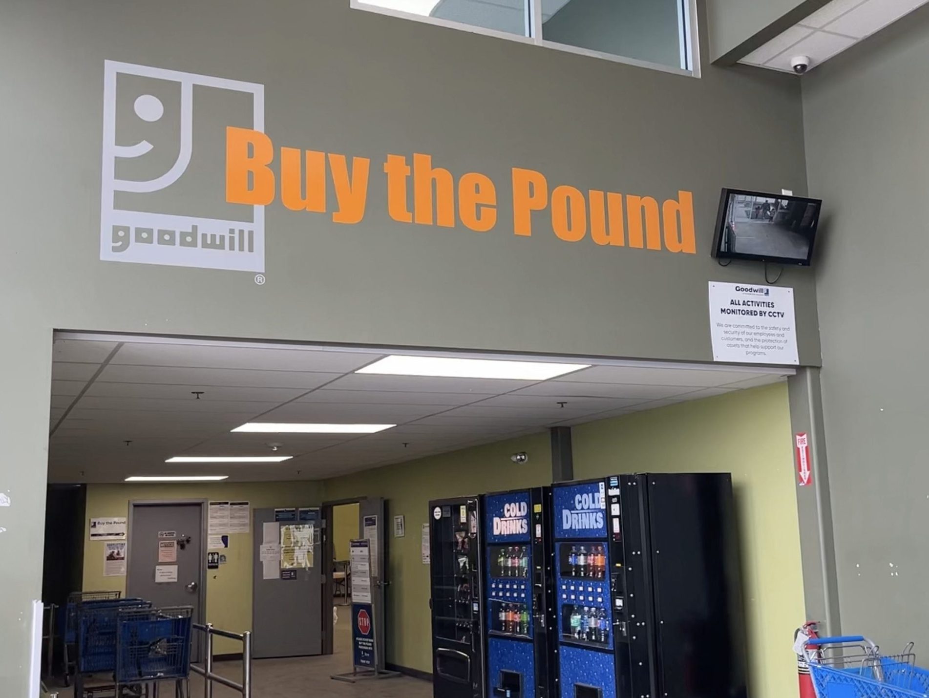 The entrance to a store with a Goodwill logo and the words "Buy the Pound."