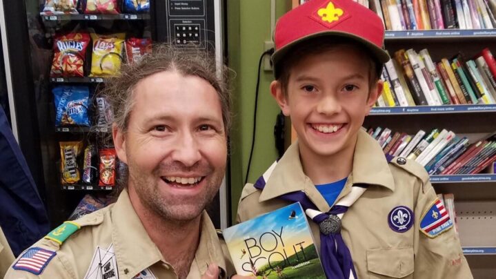 A young scout poses with Bernier after picking up his free uniform at the annual drive