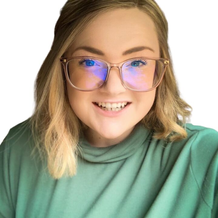 A smiling woman, Alexis, wearing a green shirt and glasses.