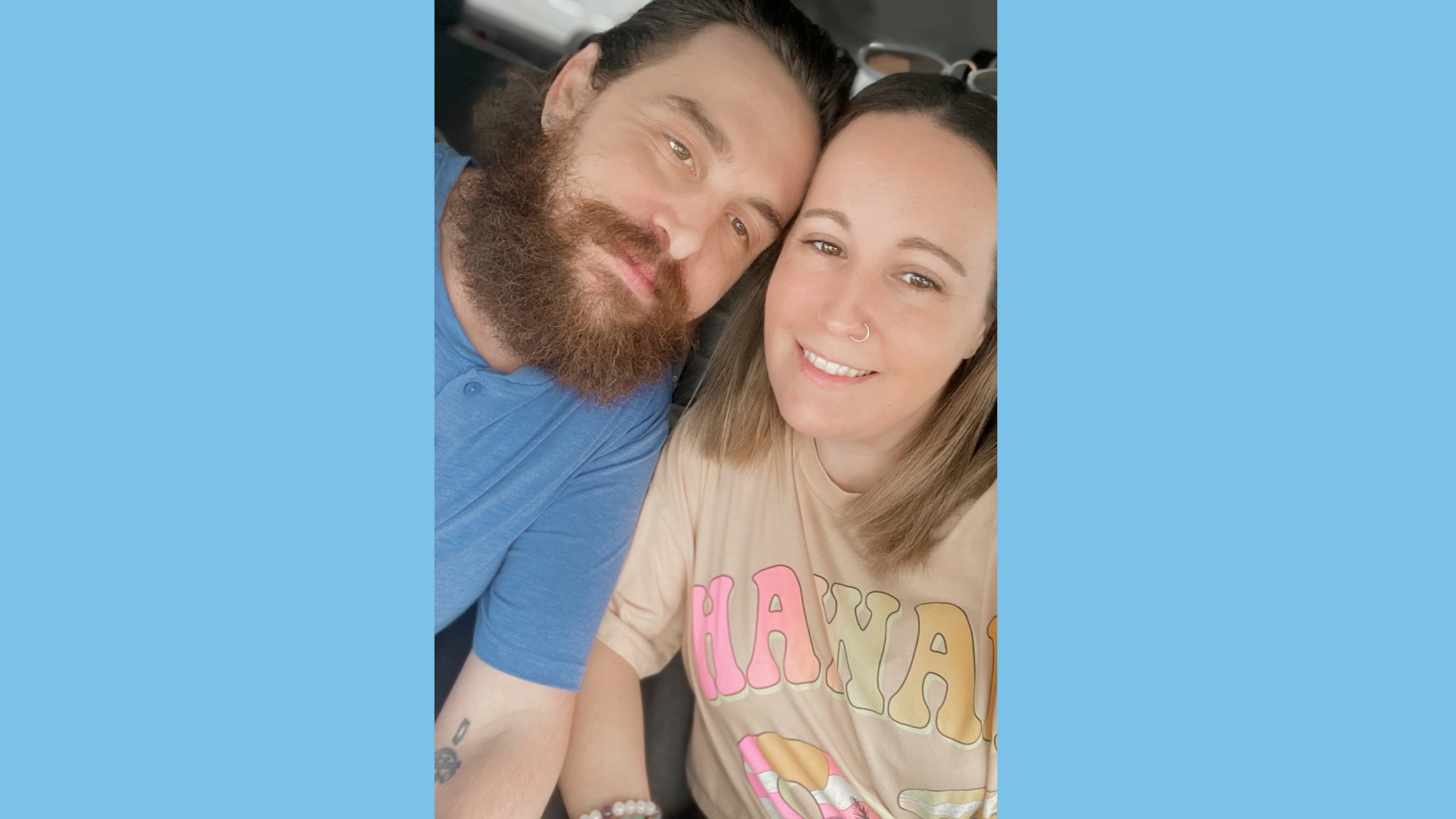 Man and woman smiling with a blue background