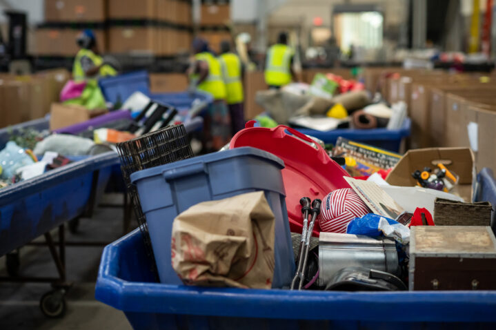 A big blue cart full of donated stuff.