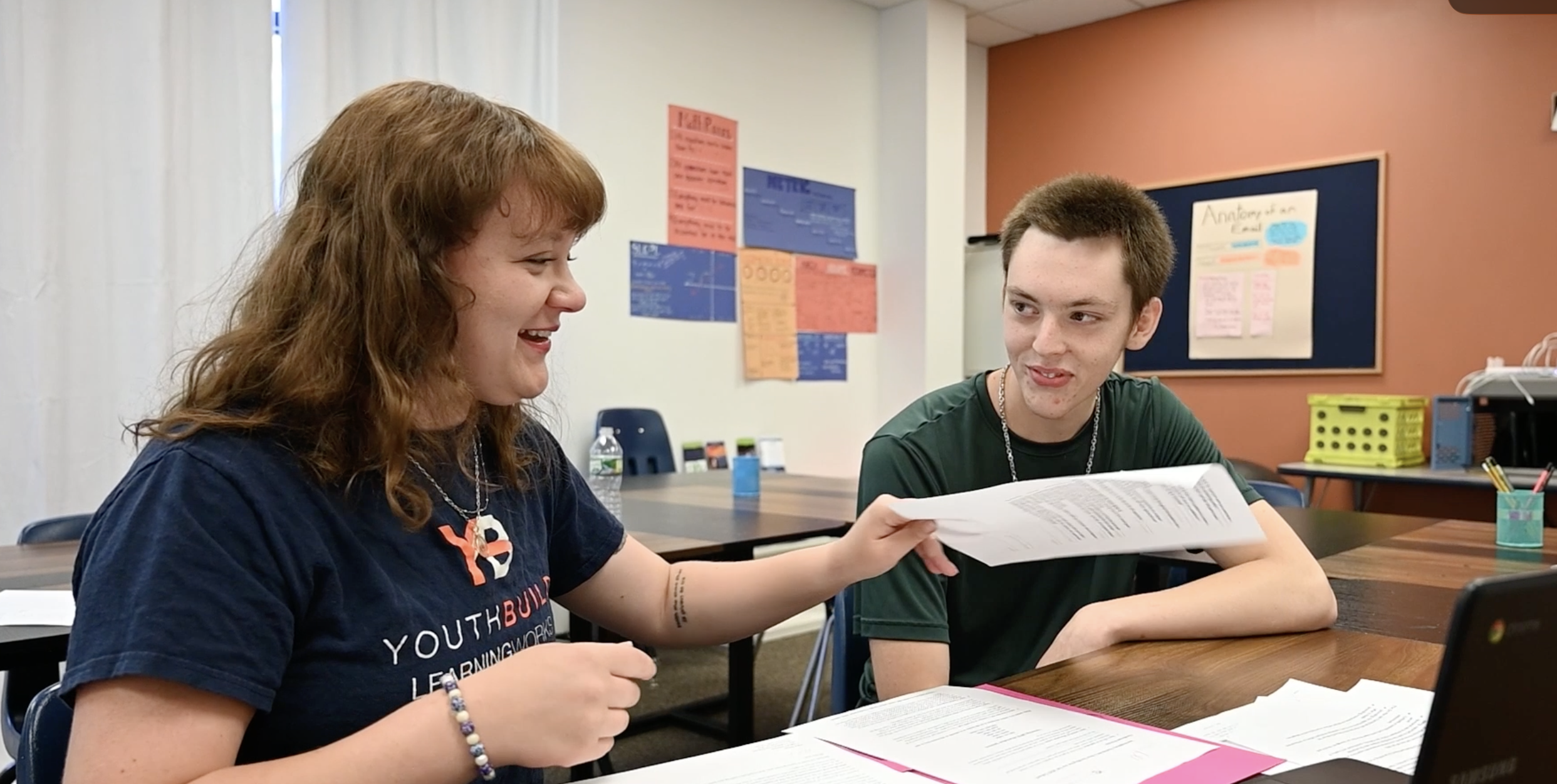 Woman and man look at and discussing paperwork