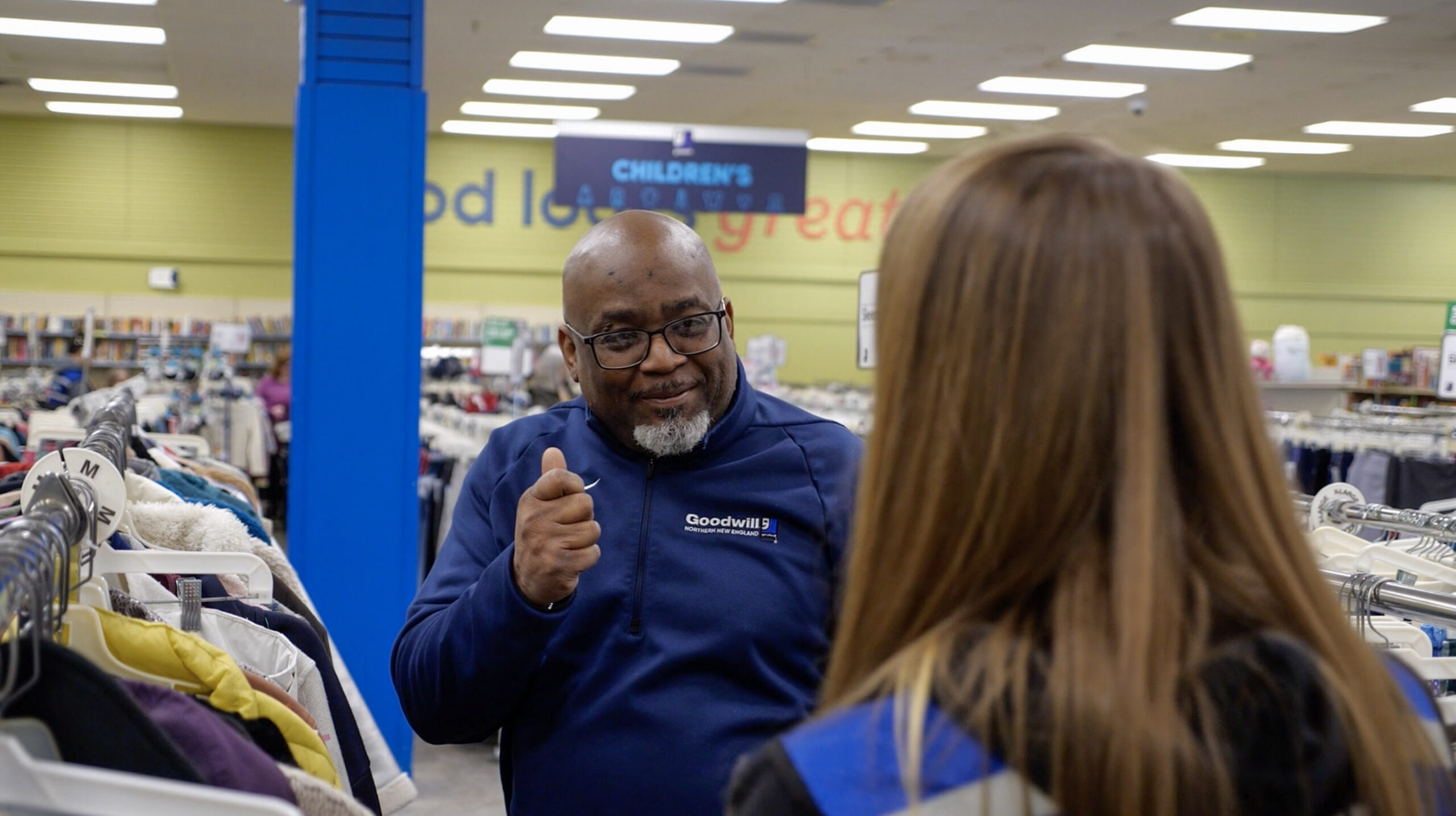 Man talking to woman who is facing away from the photo